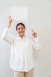 © littlestocker - Happy asian woman holding white board. Advertising copy space