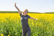 © Angelov - Young happy woman on blooming rapeseed field in spring.