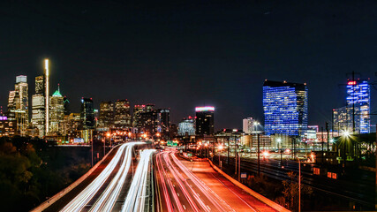 Wall Mural - Skyline of Philadelphia (PA) USA at night with car trails on a expressway, with copy space.