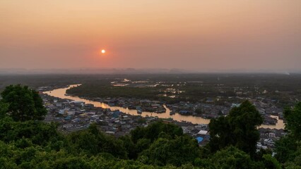 Wall Mural - Pak Nam Chumphon town, fisherman village, and river from Khao Matsee viewpoint during sunset, Thailand; day to night - time lapse.