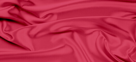 Beautiful viva magenta color banner background with drapery and wavy folds of silk satin material texture. Top view