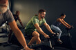 © Flamingo Images - Fit man in a gym cycling class