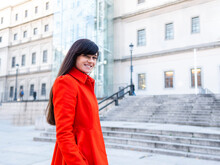Smiling Woman In Red Coat On Street