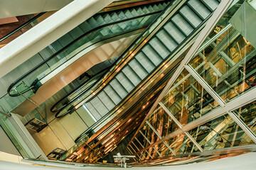 empty escalators and glass elevator, top down view