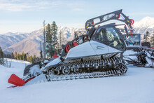 Parking On A Slope Snow Removal Equipment For A Ski Resort. Snow Plowing Bulldozer Grooming For Skiing And Snowboarding Holidays On Mountain.