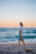 © travnikovstudio - Woman on the beach enjoying summer holidays