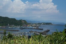 High Angle Of The Port Of Keelung City In Taiwan With Mountains And A Cloudy Sky In The Background