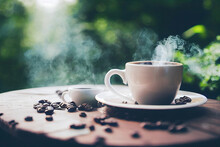 Black Coffee In White Cups With Smoke And Coffee Beans