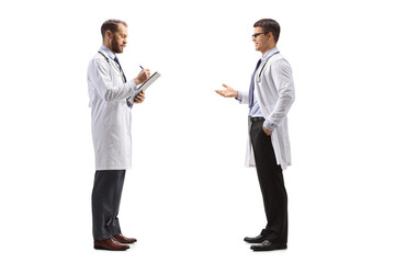 Wall Mural - Doctor talking to a colleague standing and writing a document