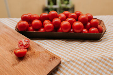 Wall Mural - Fresh ripe red cherry tomatoes in a bowl on the table. Healthy food, organic vegetables. Natural vitamins, food raw materials. Handpicked bio tomato
