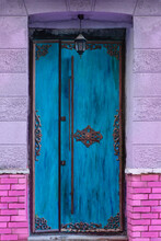 Colorful Antique Turquoise Blue Door  In A Pink Wall.