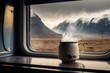 Steaming cup of coffee on the window sill of a campervan - Van Life and Slow living