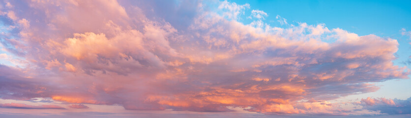 Beautiful panoramic sky with glowing clouds at sunset	