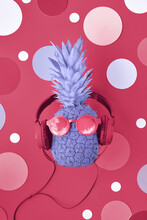 Viva Magenta Color Of The Year 2023. Funny Pineapple Painted Purple On Magenta Background With Various Disco Circles. Pineapple Character In Sunglasses And Earphones.