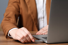 Woman Attaching Usb Flash Drive Into Laptop At Wooden Table, Closeup