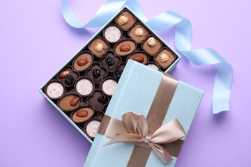 Poster - Open box of delicious chocolate candies on violet background, flat lay