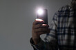 © Mihail - hand holding a smartphone used as a torched, flashlight of mobile phone in the dark