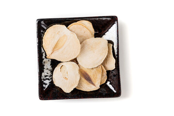 Wall Mural - Sliced dried shallots in a pile on a black tray top down