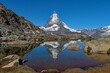 The peak of the Matterhorn reflecting on the water of a lake in Switzerland 
