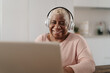 © Alessandro Biascioli - Happy senior woman having fun using a laptop in her house - Technology and smart working concept