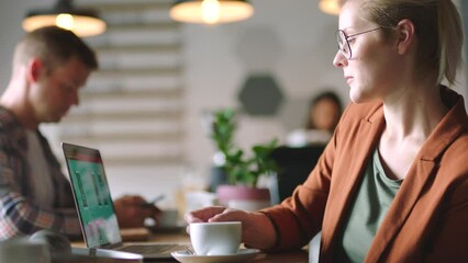 Poster - Coffee, laptop and profile of business woman in office drinking espresso, caffeine or cappuccino while working on a project with coworkers. Tea, computer and female employee in workplace with staff.