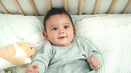 Sticker - Adorable hispanic baby smiling confident lying on bed at bedroom