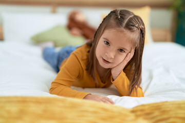 Poster - Adorable hispanic girl smiling confident lying on bed at bedroom