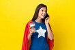 © luismolinero - Super Hero Brazilian woman isolated on yellow background holding coffee to take away and a mobile