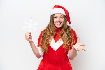 Wall Mural - Young caucasian woman with Christmas dress holding snowflake isolated on white background with shocked facial expression