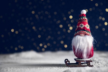 A Christmas Gnome On A Sled In The Snow. New Year's, Christmas Background
