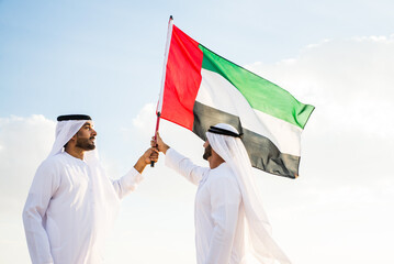 Wall Mural - Arab men wearing typical middle eastern clothing in the desert