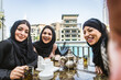 © oneinchpunch - Arabic women wearing traditional middle eastern abaya clothing in Dubai, shopping and having fun outdoors