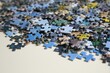 © New Africa - Puzzle pieces on white table, closeup view