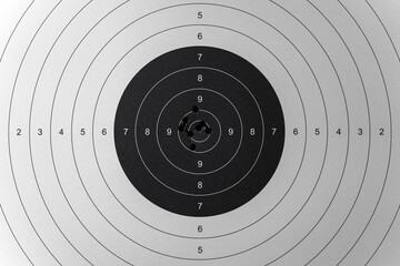 Shooting range target with bullet holes in the center.