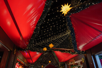 Wall Mural - Night atmosphere of Weihnachtsmarkt, Christmas Market  with various beautiful decorated illuminate stalls beside Cologne Cathedral in Köln, Germany.