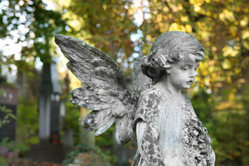 Beautiful statue of angel at cemetery. Religious symbol