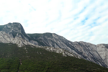 Majestic mountain landscape covered with greenery on cloudy day