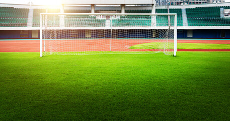 Wall Mural - Empty soccer ball green grass field