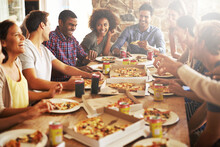 Friends, happy with pizza at restaurant, fast food and soda with group on lunch or dinner date, happiness and nutrition. Food, friendship and meal at New York pizzeria, party and social gathering.