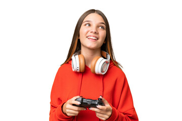 Poster - Teenager caucasian girl playing with a video game controller over isolated background laughing