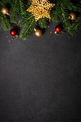 Wall Mural - Christmas flat lay background with holiday decorations. Vertical format. Flat lay image on black with copy space.