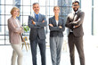 © ty - Group of businesspeople standing together in office.