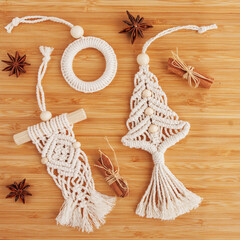 Wall Mural - Christmas tree macrame toys on wooden boad.  Natural materials - cotton thread, wood beads and stick. Eco decorations, ornaments, hand made decor. Winter and New Year holidays.