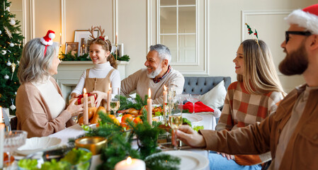 Sticker - Happy big family with children exchanging gifts on Christmas morning at home