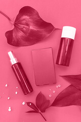 Trendy Color of the year 2023: Viva Magenta toned cosmetic products backdrop
