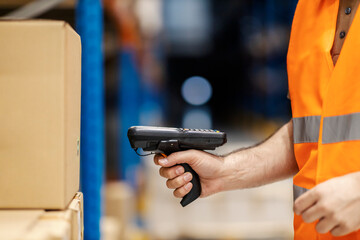 Wall Mural - Close up of worker loading bar code with reader in storage.