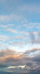 Wall Mural - fantastic clouds at sunrise, vertical panorama