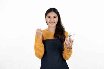 Happy young asian woman business owner wear apron and holding smartphone for checking order from customer isolated on white background for SME franchise investment concept.