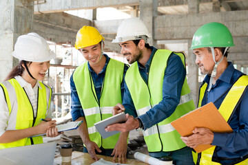 team of civil engineer manager, maintenance supervisor, professional technician foreman together with safety operator inspect and discuss the infrastructure of building construction progress at site