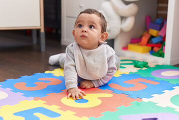 Wall Mural - Adorable hispanic baby crawling on floor at kindergarten